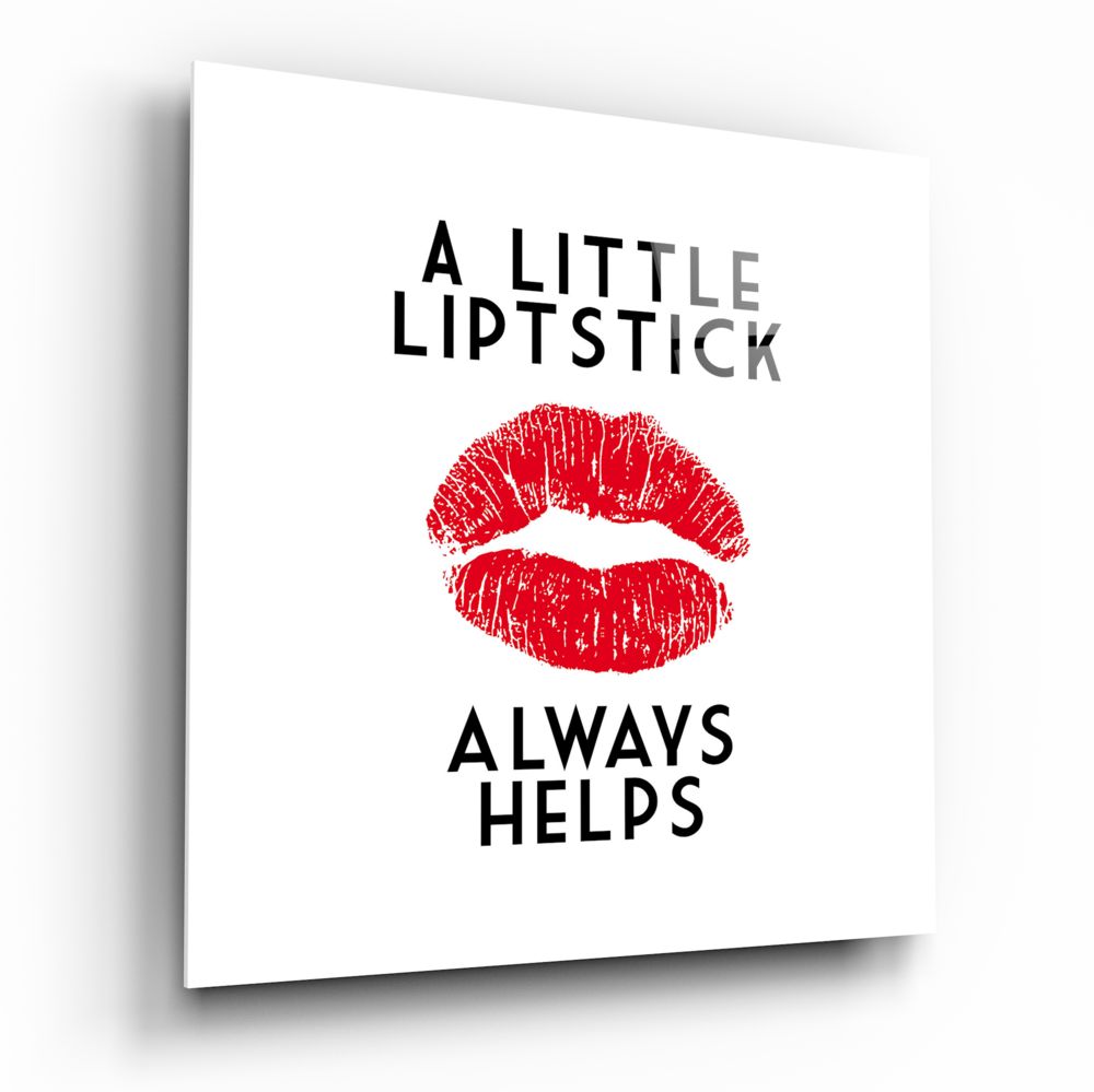 White glass wall art with black text reading "A LITTLE LIPSTICK ALWAYS HELPS" and a red lipstick kiss mark print in the center.