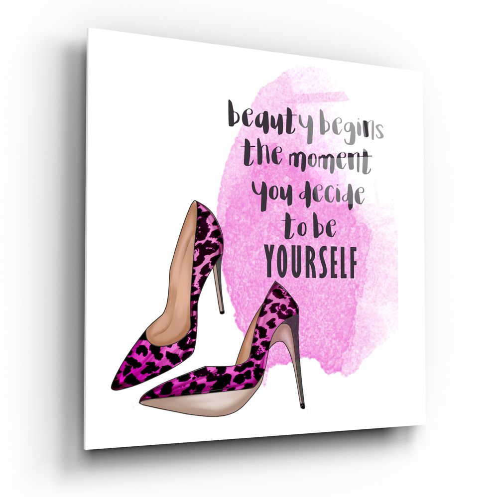 Glass wall art displaying pink leopard print heels with inspirational text "beauty begins the moment you decide to be yourself" on white background.