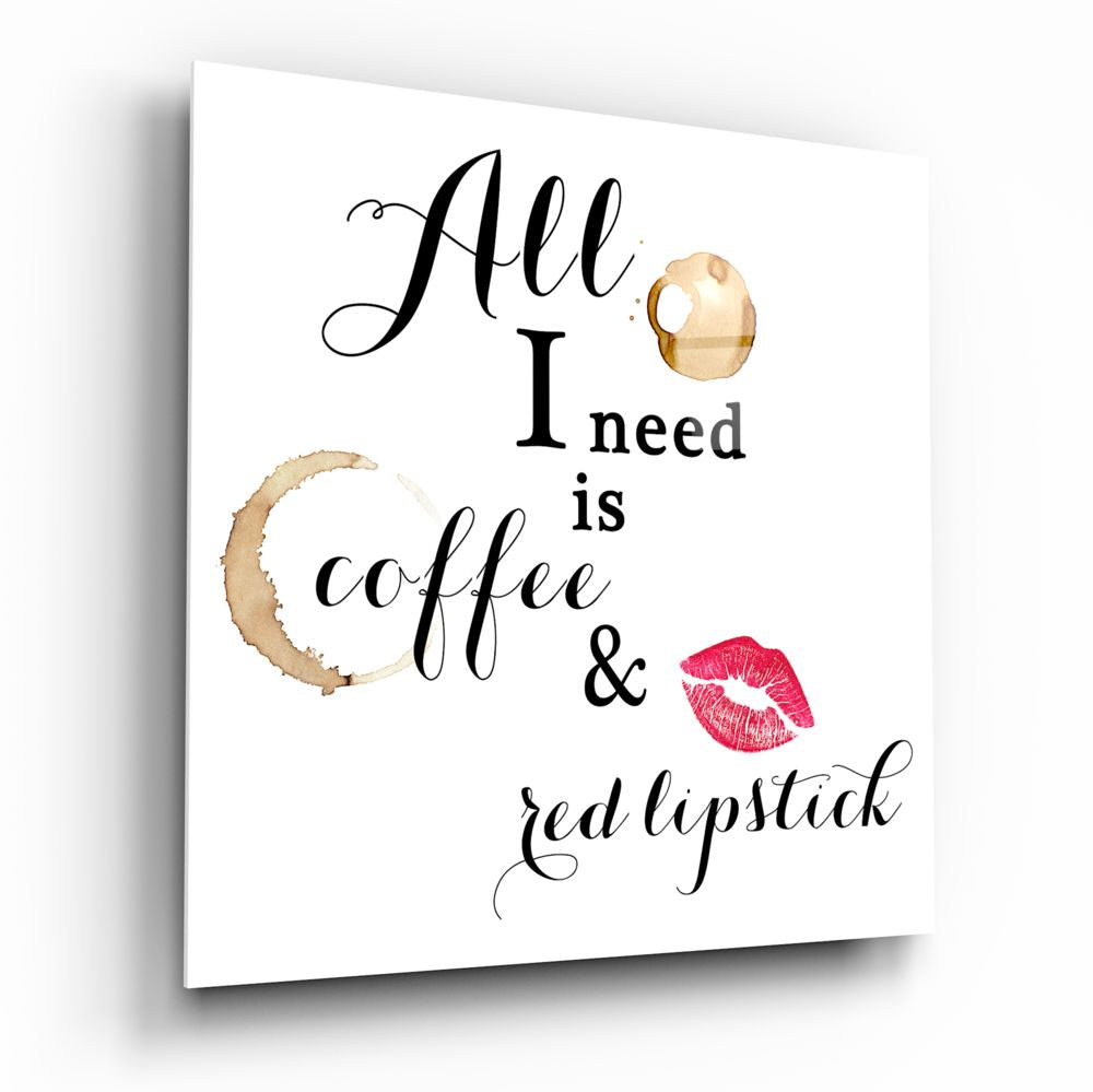 White glass wall art panel displaying black script text reading "All I need is coffee & red lipstick" with watercolor coffee stain and pink lipstick mark illustrations.