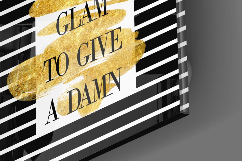 Gold foil glass wall art with black and white striped background displaying "I CLAIM TO GIVE A DAMN" text, angled perspective view.