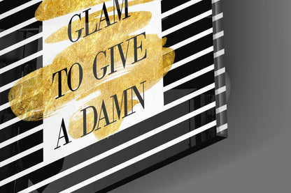 Gold foil glass wall art with black and white striped background displaying "I CLAIM TO GIVE A DAMN" text, angled perspective view.