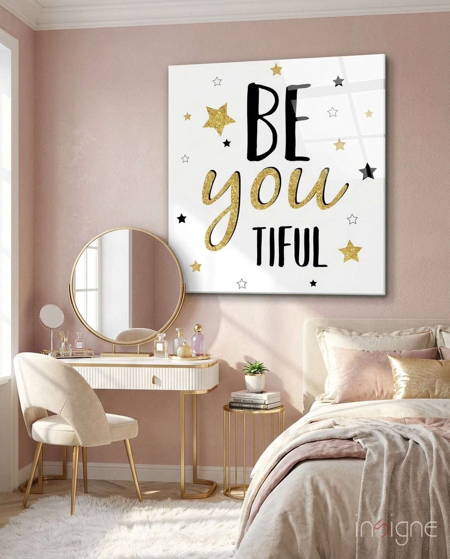 Motivational glass wall art with "BE you TIFUL" text and gold and black stars displayed above a vanity in a pink bedroom.