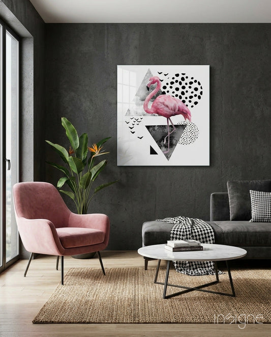 Pink flamingo geometric glass wall art displayed above a round white table in a modern living room with dark walls and pink chair.