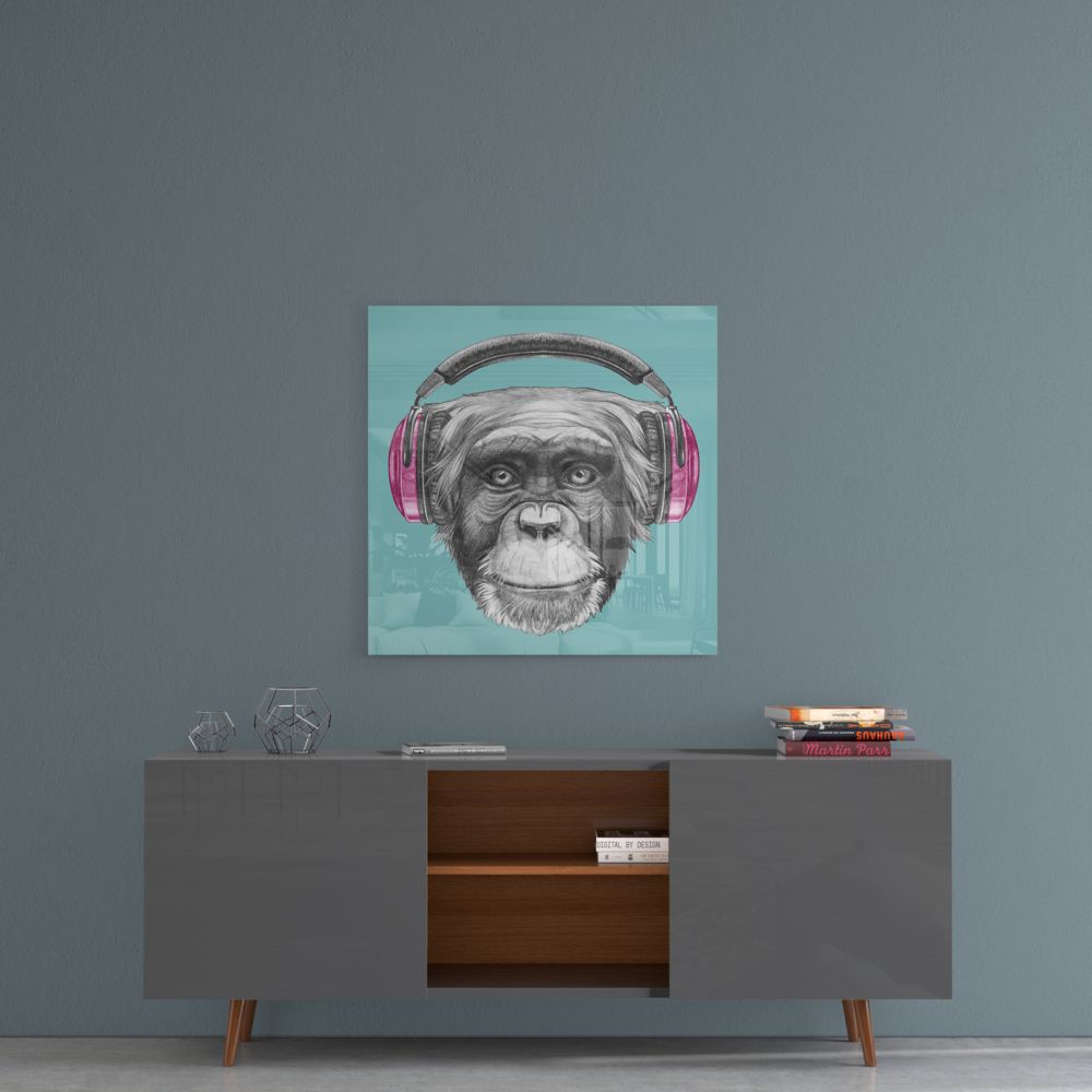 Monkey Glass Wall Art displayed above a mid-century modern console table, featuring a chimpanzee wearing pink headphones against a turquoise background.