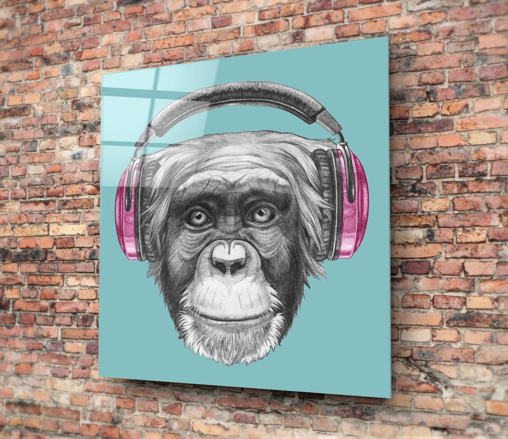 Square turquoise glass panel with black and white sketch of a chimpanzee wearing pink and gray headphones, mounted on a brick wall.