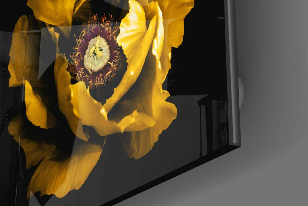 Close-up angled view of yellow glass wall art featuring a large golden peony flower with deep burgundy center against dark background.