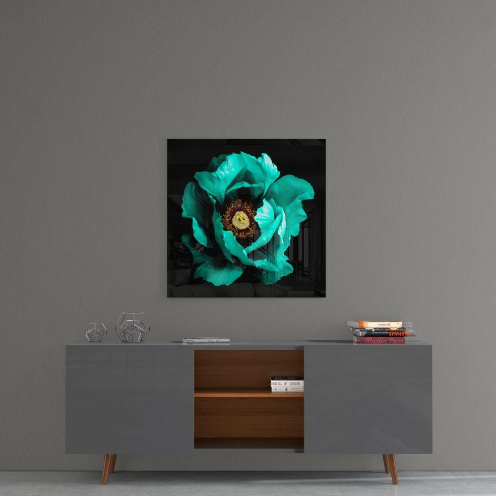 Turquoise peony with dark center displayed as glass wall art above gray mid-century console table.