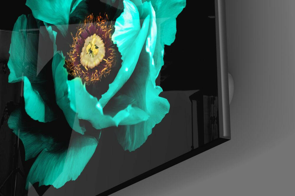 Turquoise glass wall art featuring a large peony flower with yellow and burgundy center, photographed at an angle against a dark background.