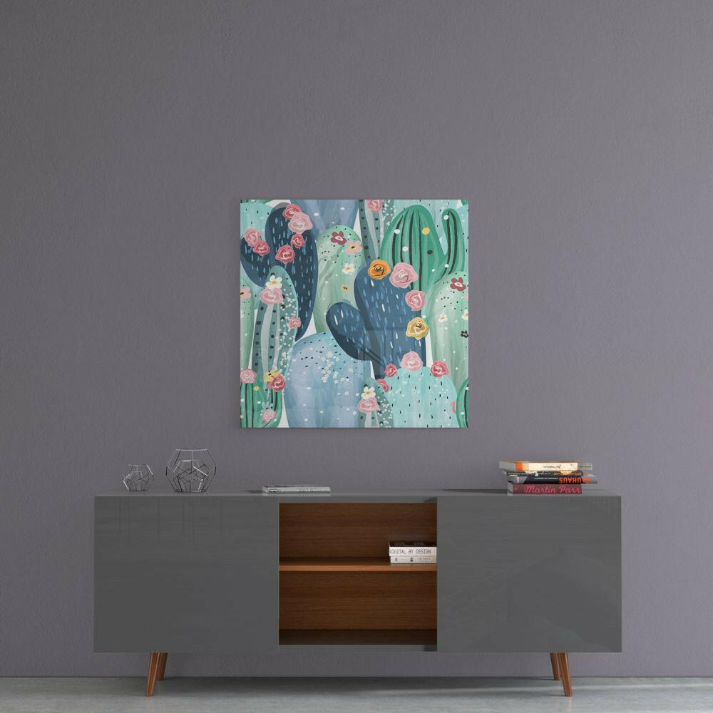 Colorful glass cactus wall art with pink and orange flowers displayed above a mid-century modern gray sideboard with wooden shelving.