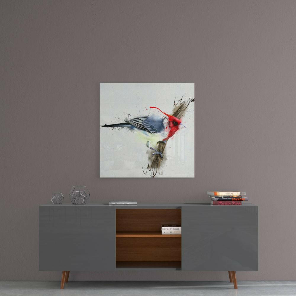 Red bird glass wall art with blue, red, and yellow watercolor splashes displayed above a gray mid-century modern credenza.