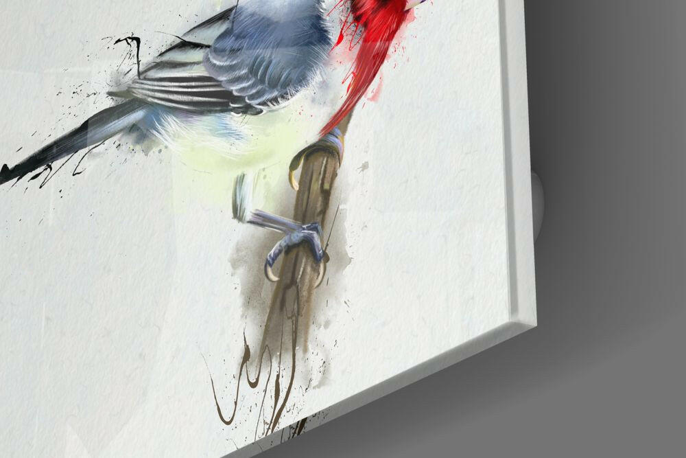 Close-up angled view of red bird glass wall art with paintbrush and blue twine detail on white background.