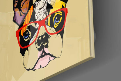 Colorful pop art bulldog wearing red-framed glasses on cream-colored glass wall art, displayed at an angle showing depth and shadow.