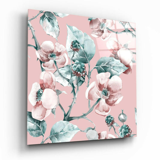Square glass wall art panel angled from above displaying watercolor peonies in pink and teal on pale pink background.