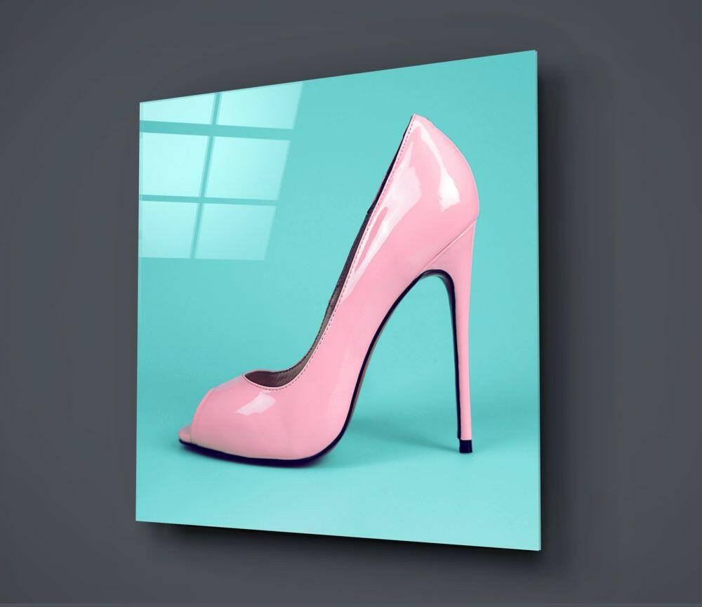 Pink glossy high-heeled pump displayed on turquoise glass panel against gray background, angled three-quarter view.