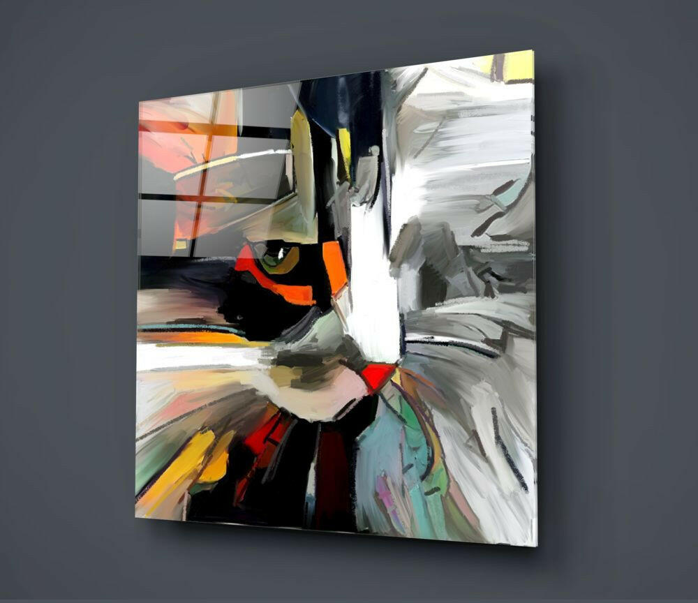 Abstract cat face glass wall art displaying bold brushstrokes in orange, black, white, and multicolored accents, mounted on gray wall.