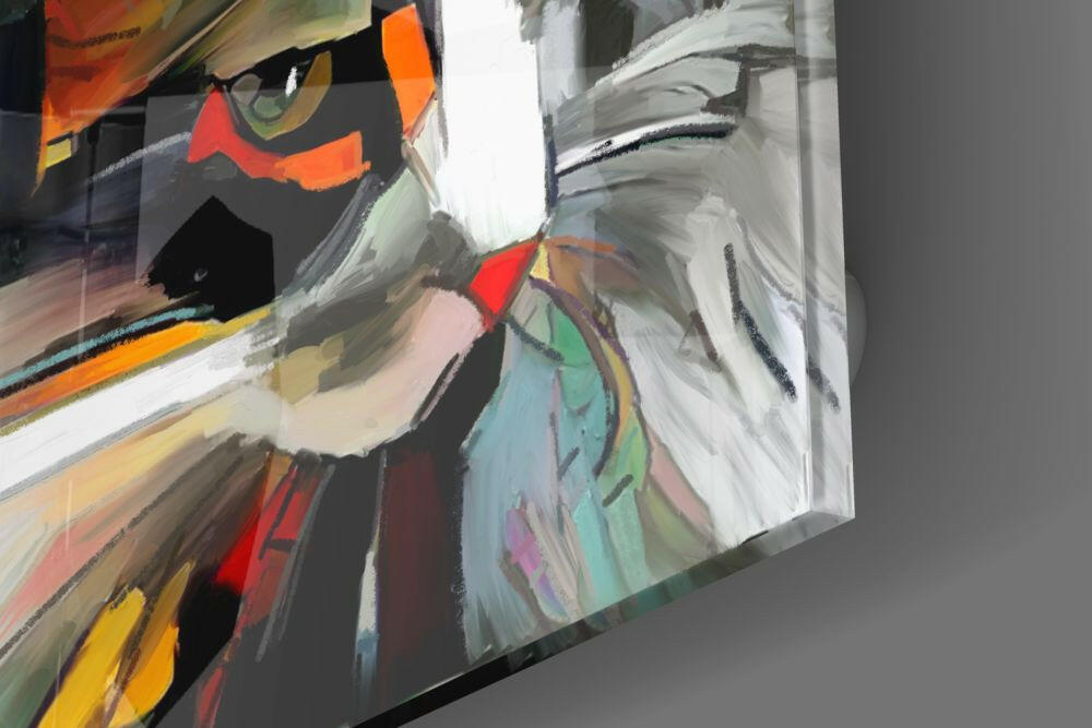 Close-up angled view of abstract cat glass wall art showing colorful painted face with orange, red, blue, and green brushstrokes on white and grey background.