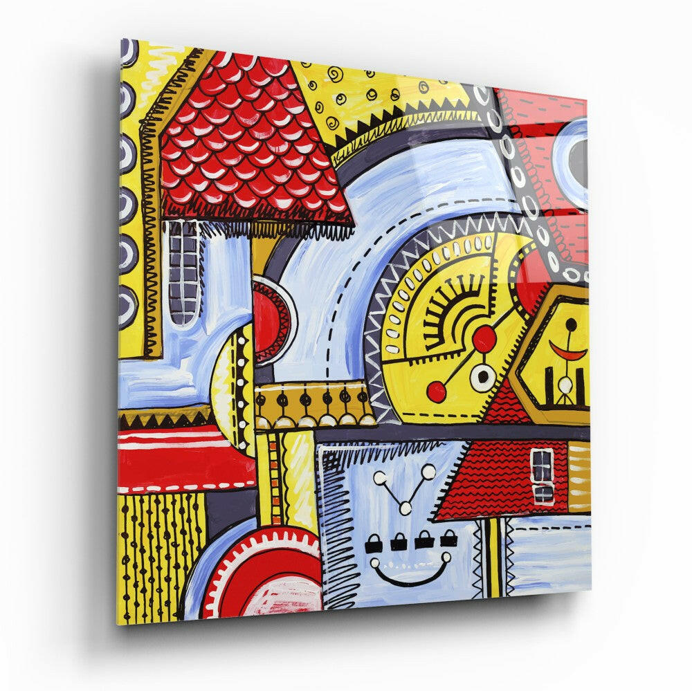 Angled view of colorful glass wall art featuring bold geometric houses in yellow, red, and blue with decorative patterns and a smiling face design.