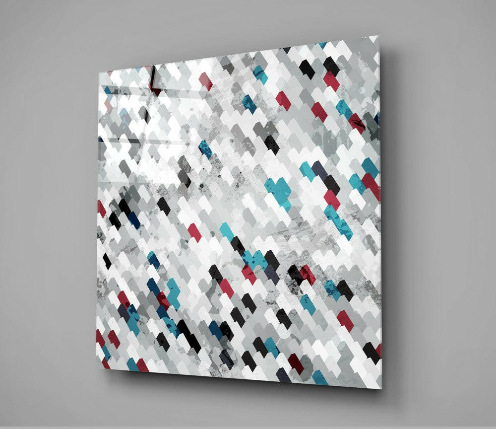 Angled view of glass wall art featuring a geometric diamond pattern in teal, red, black, gray, and white tiles with textured overlay.