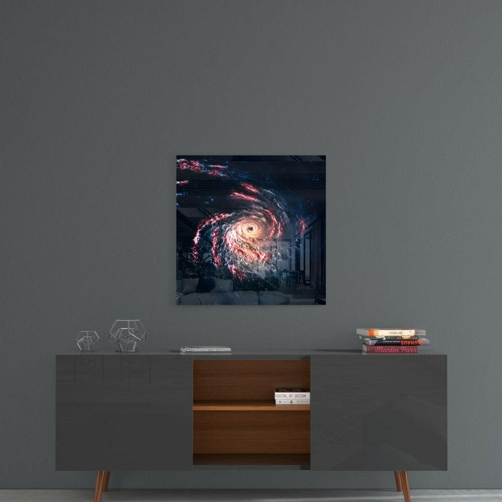 Black hole glass wall art with pink and white spiral galaxy displayed on gray wall above mid-century modern console table.