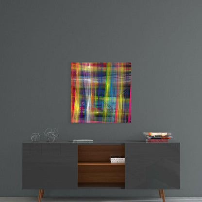 Vibrant multicolored glass art with vertical streaks of red, yellow, blue, and pink displayed above a mid-century modern console table.