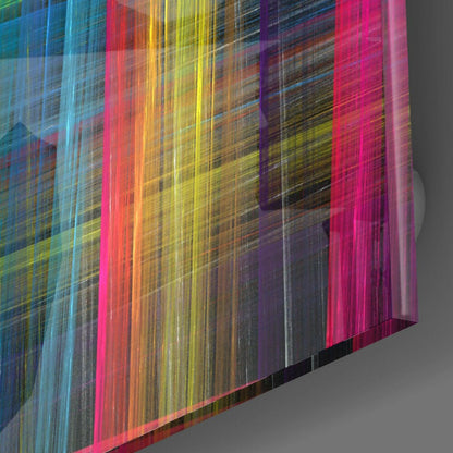 Angled view of translucent glass wall art displaying vertical stripes in blue, red, orange, yellow, and pink hues against gray background.