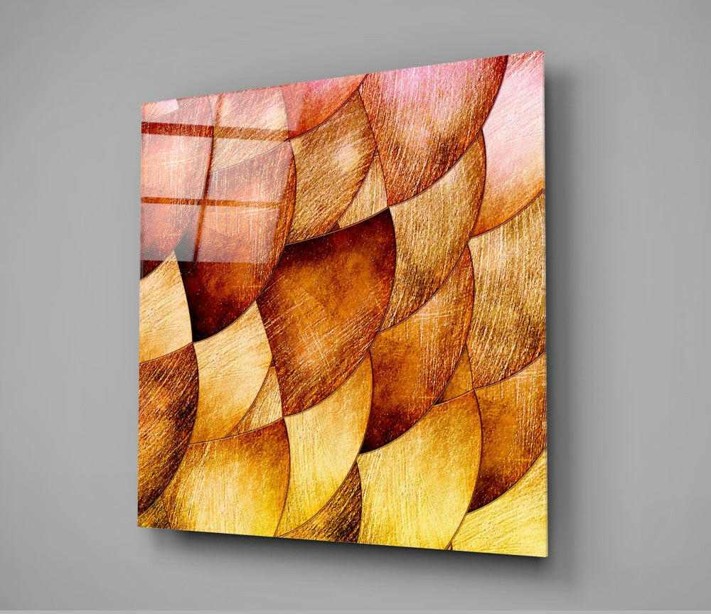 Gold Shells Glass Wall Art displayed at an angle, showing overlapping shell-shaped tiles in warm gold, amber, and coral tones with textured surfaces.