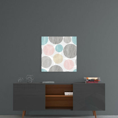 Soft Spots Glass Wall Art displayed above a mid-century modern credenza, featuring pastel circles in pink, blue, tan, and black striped patterns on white background.