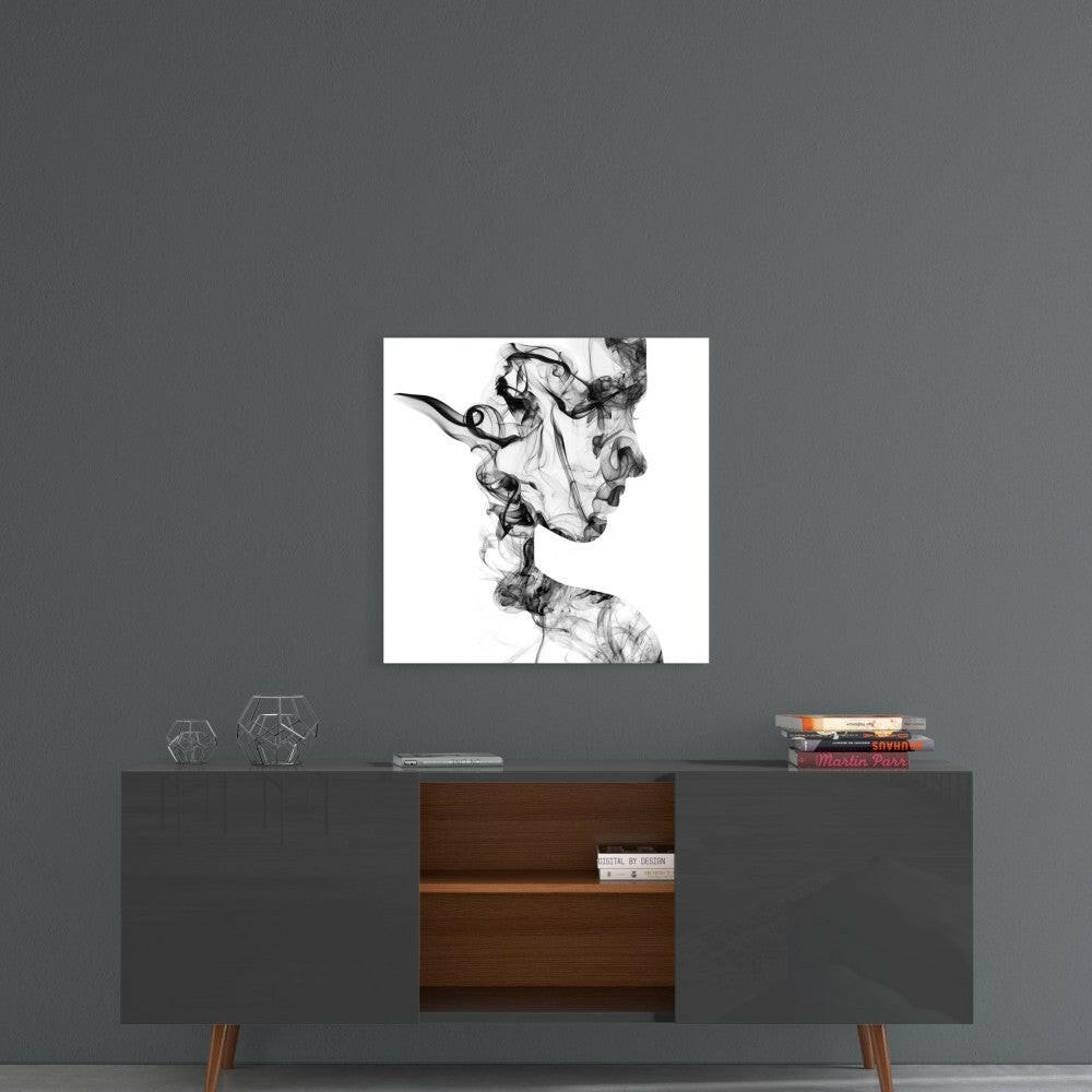 Black and white ink smoke silhouette artwork displayed on gray wall above mid-century modern console table with books and geometric decorative objects.