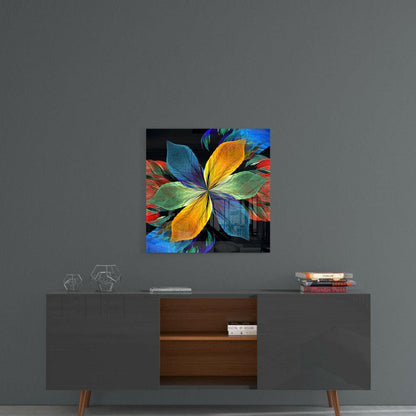 Colorful glass wall art with vibrant yellow, blue, green, and red petals displayed on gray wall above mid-century modern console table.