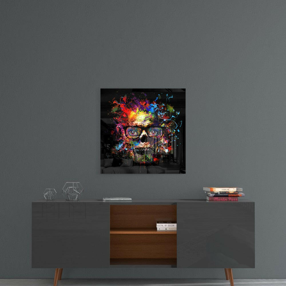 Colorful skull glass wall art with vibrant neon paint splatters displayed above a mid-century modern console table.
