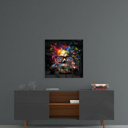 Colorful skull glass wall art with vibrant neon paint splatters displayed above a mid-century modern console table.