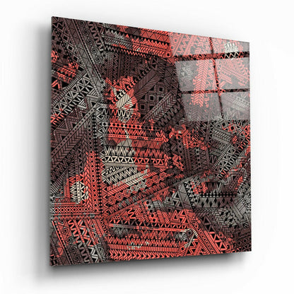Angled perspective view of glass wall art featuring intricate geometric patterns in red, black, and white tribal designs.