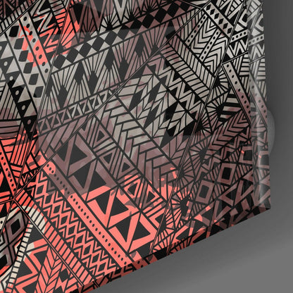 Close-up angled view of geometric patterned glass wall art featuring black, coral red, and gray abstract designs with triangles and linear details.