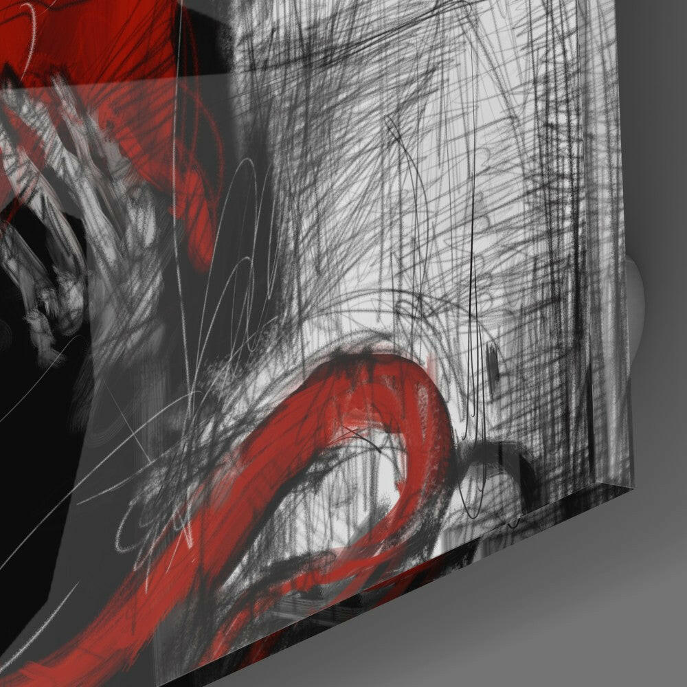 Close-up angled view of glass wall art showing red curved brushstrokes and black line drawings on translucent surface.