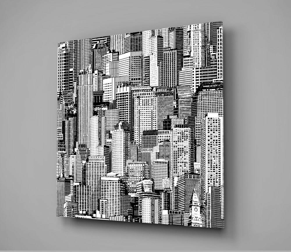Black and white glass wall art displaying an intricate cityscape of densely packed skyscrapers shown at an angled perspective against a gray background.