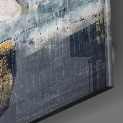 Angled close-up of glass wall art edge showing layered urban architectural landscape with grey tones and gold accents.
