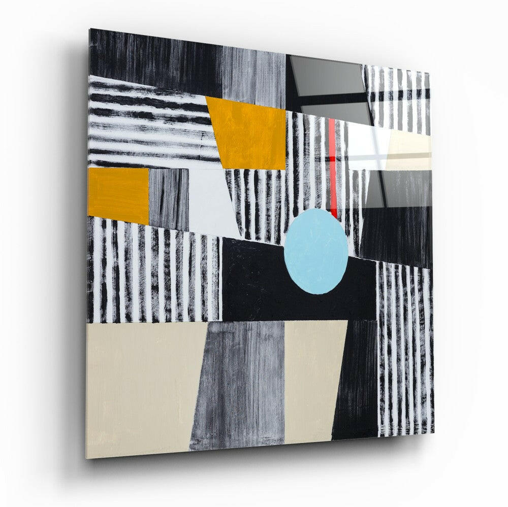 Abstract glass wall art featuring geometric shapes in black, white, gray, mustard yellow, light blue, and cream, displayed at an angle against white background.