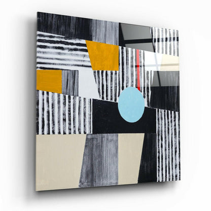 Abstract glass wall art featuring geometric shapes in black, white, gray, mustard yellow, light blue, and cream, displayed at an angle against white background.