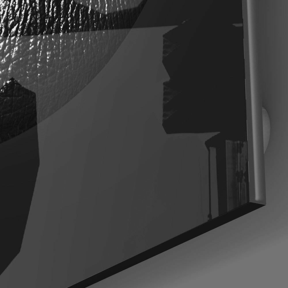 Black lips profile silhouette mounted on white wall with shower head above, side angle view.