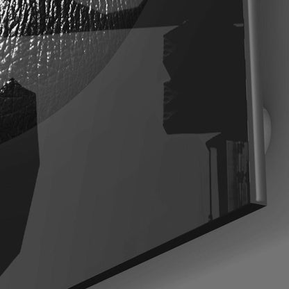 Black lips profile silhouette mounted on white wall with shower head above, side angle view.