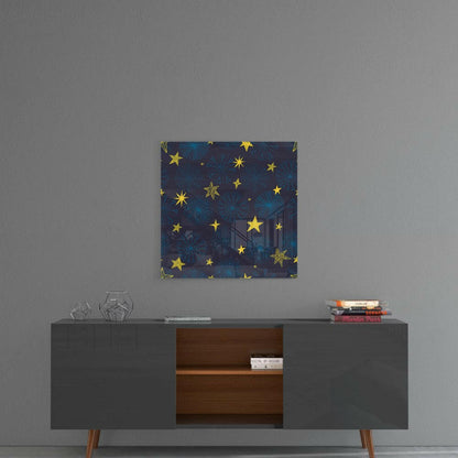 Square glass wall art with dark blue background, gold stars, and snowflake patterns hanging above mid-century modern credenza.
