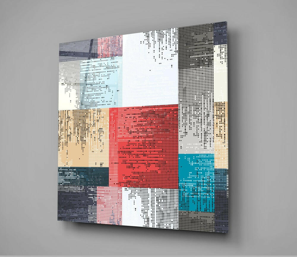 Angled view of pixelated patchwork glass wall art featuring red, teal, tan, grey, and white geometric sections with dotted pattern texture.