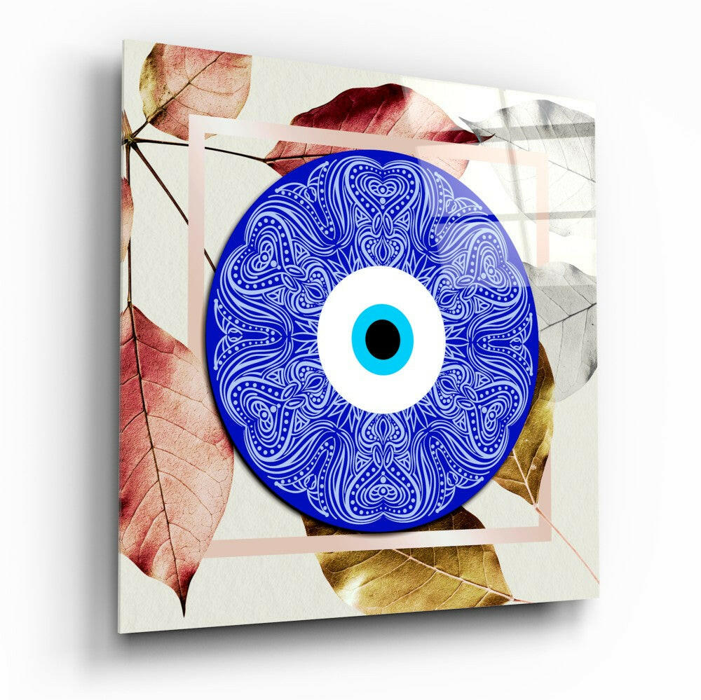 Blue ornamental evil eye glass wall art with cyan iris centered on cream background surrounded by autumn leaves in red and gold tones.