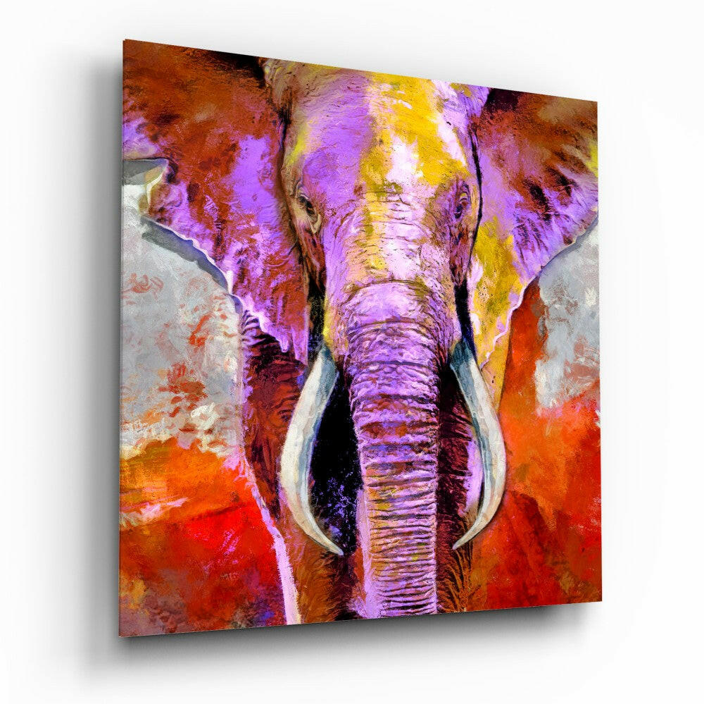 Vibrant glass wall art featuring a front-facing elephant in purple, yellow, and orange hues against a warm red background.