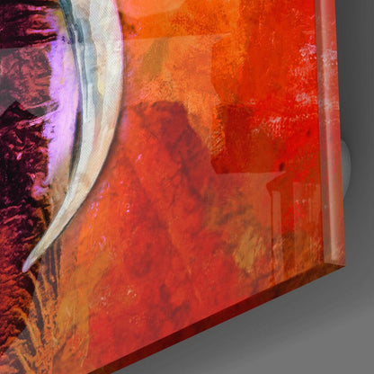 Close-up angled view of glass wall art showing vibrant red, orange, and purple gradient with textured elephant silhouette and white brushstroke detail.