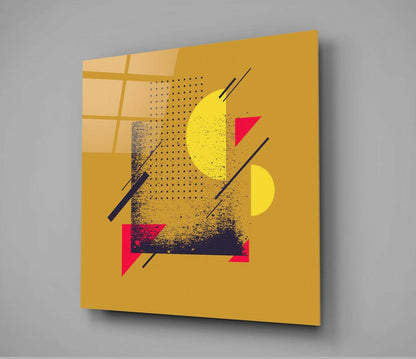 Moon Section Glass Wall Art displayed at an angle against gray background, showing gold panel with yellow circles, pink triangles, dotted pattern, and dark lines.