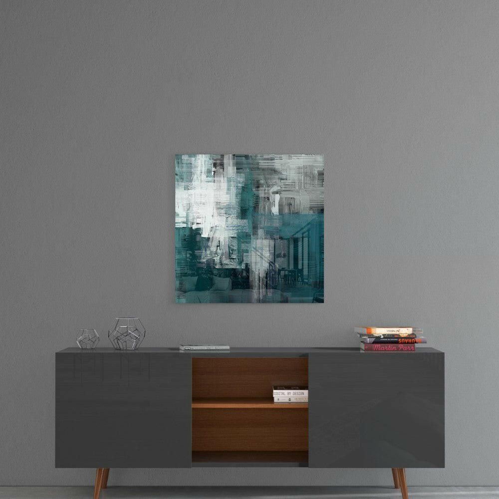 Abstract glass wall art with teal, white, and gray layered brushstroke design hung above mid-century modern credenza.