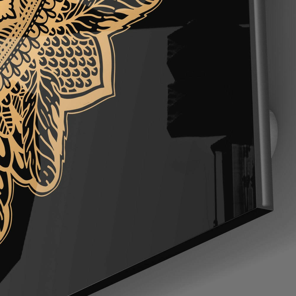 Close-up angle of gold and black lace-patterned glass panel against dark background, showing intricate detail.