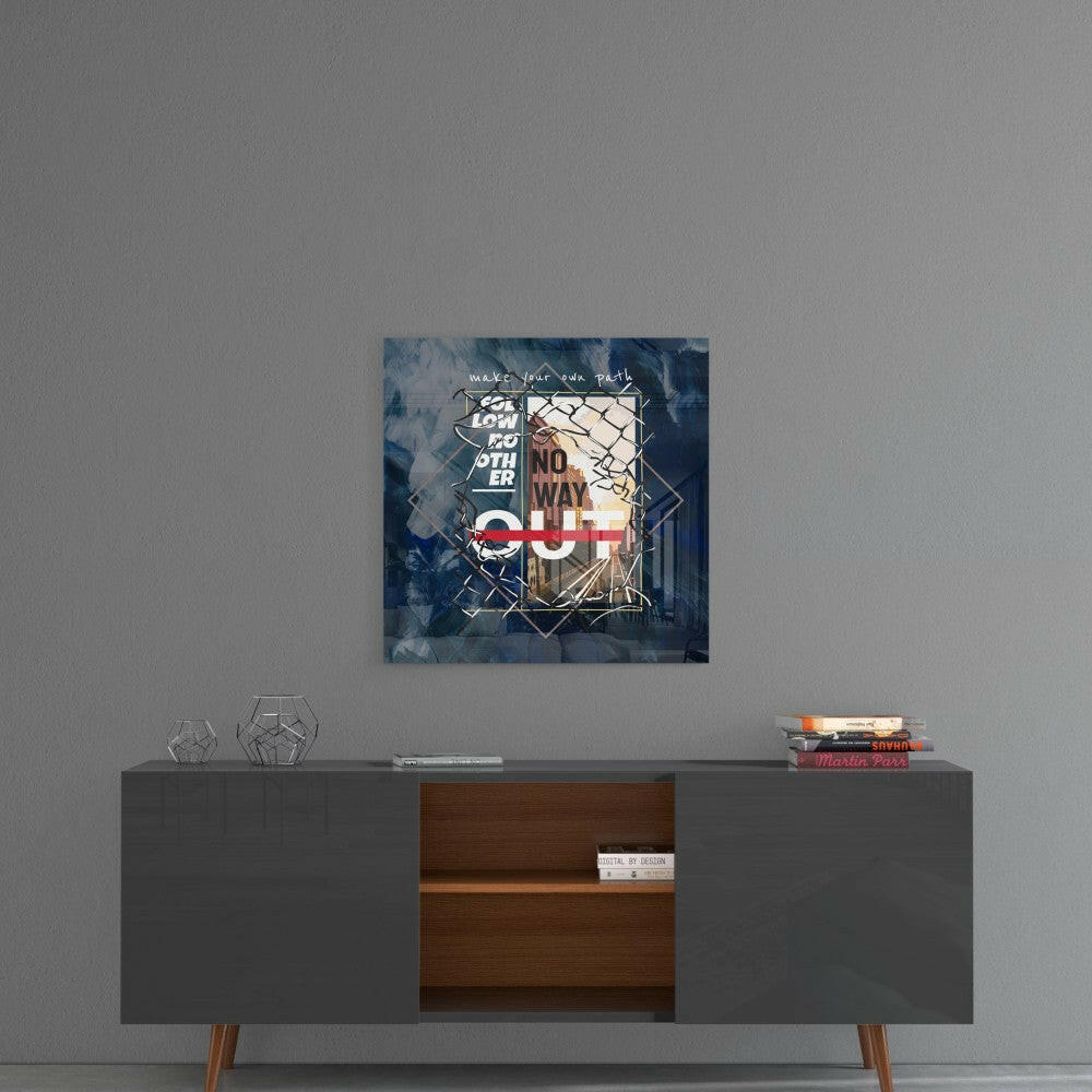 Glass wall art with geometric shapes and blue tones displayed above a mid-century modern credenza with books.