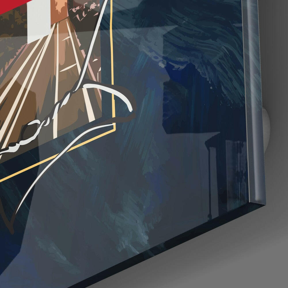 Angled side view of glass wall art panel displaying a sailing ship illustration with brown and blue tones against a gray wall.